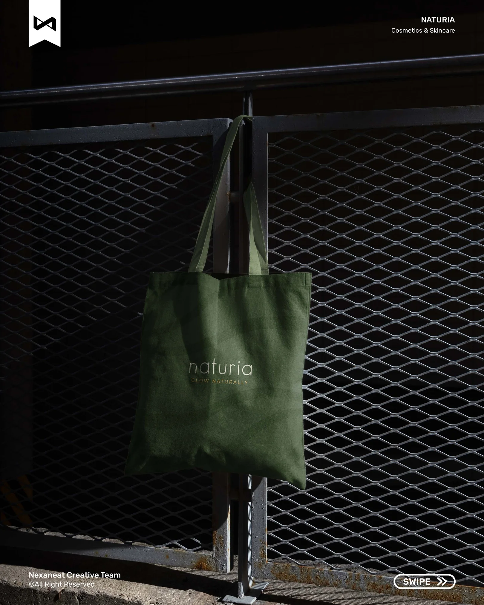Tote bag with embroidered wordmark against industrial mesh